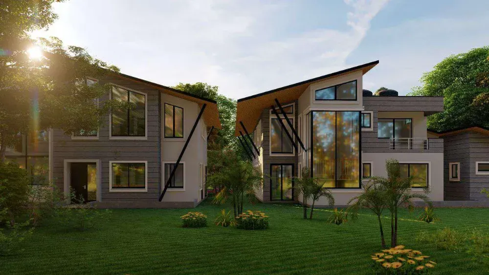 A large house with a lot of windows is surrounded by trees and grass.