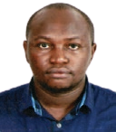 James in a blue shirt, looking directly at the camera with a neutral expression.