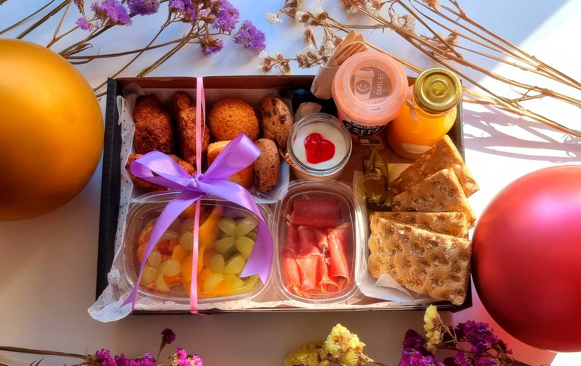 Una caja de comida con una cinta morada atada alrededor.