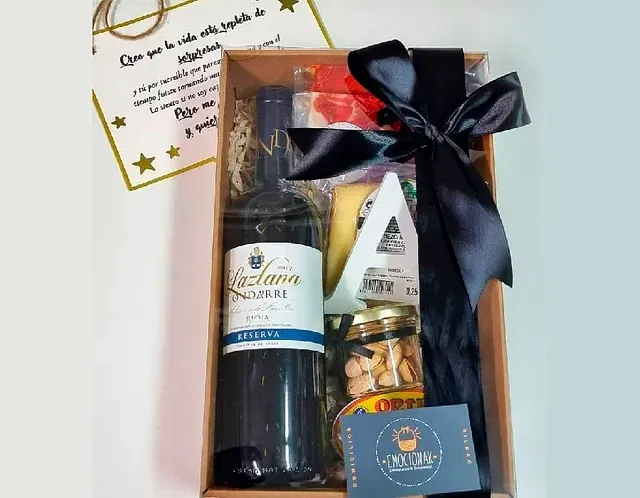 Una caja de regalo con una botella de vino y nueces.