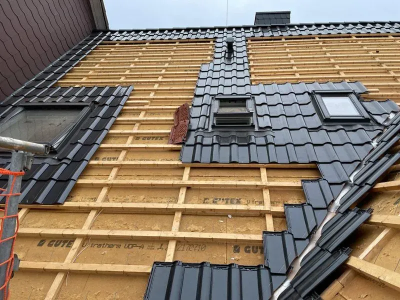 Es wird ein Dach mit vielen Ziegeln gebaut.