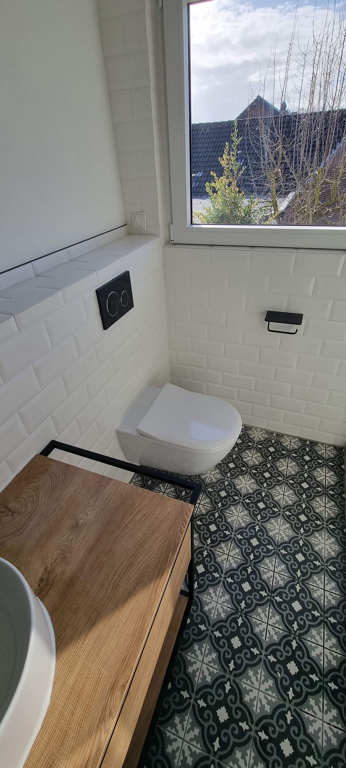 Ein Badezimmer mit Toilette, Waschbecken und Fenster.