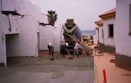 Un grupo de trabajadores de la construcción está trabajando en un camino de entrada de hormigón.