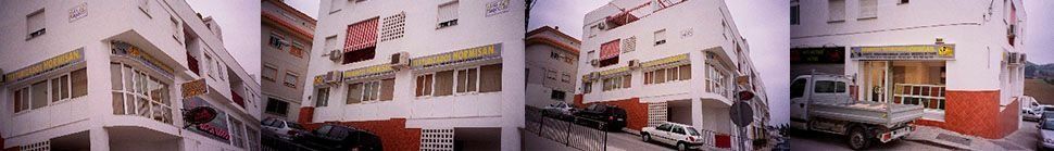 Una imagen borrosa de un edificio con coches aparcados delante de él.