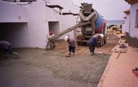 Un camión de hormigón está vertiendo hormigón en un sitio de construcción.