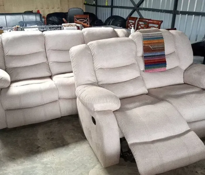 A couch and recliner are sitting in store