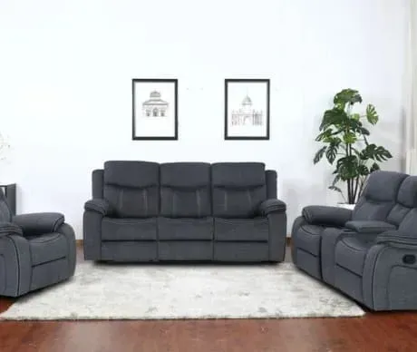 A living room with a couch , two chairs , and a rug.