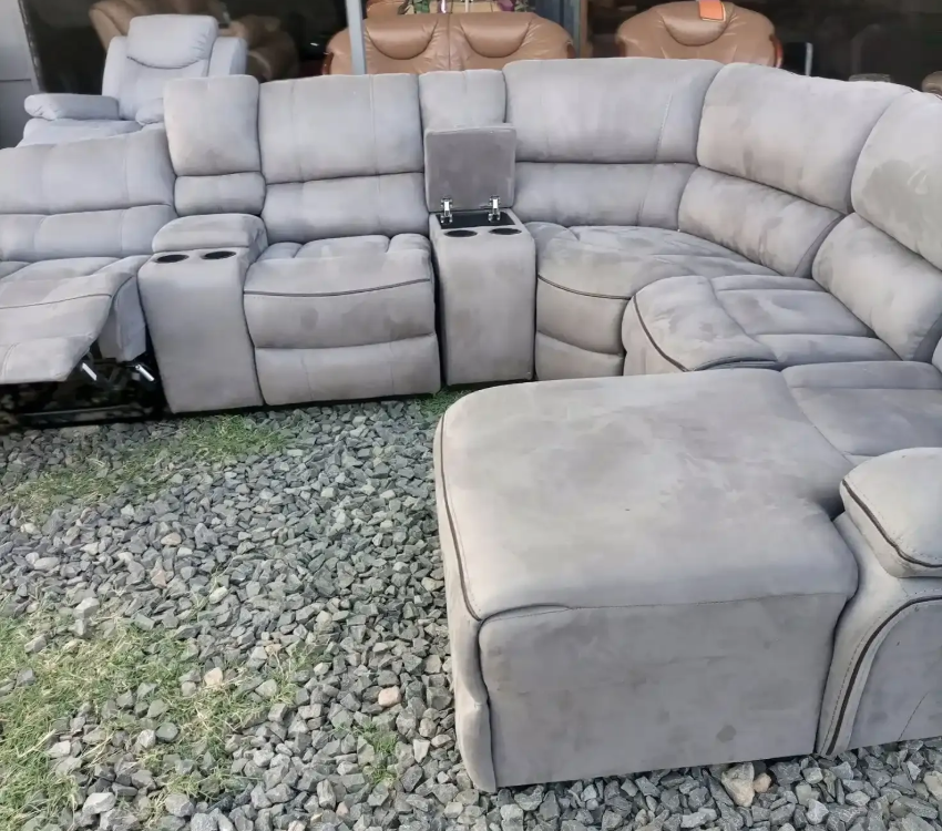 A woman is sitting at a table with a laptop and a cup of coffee.