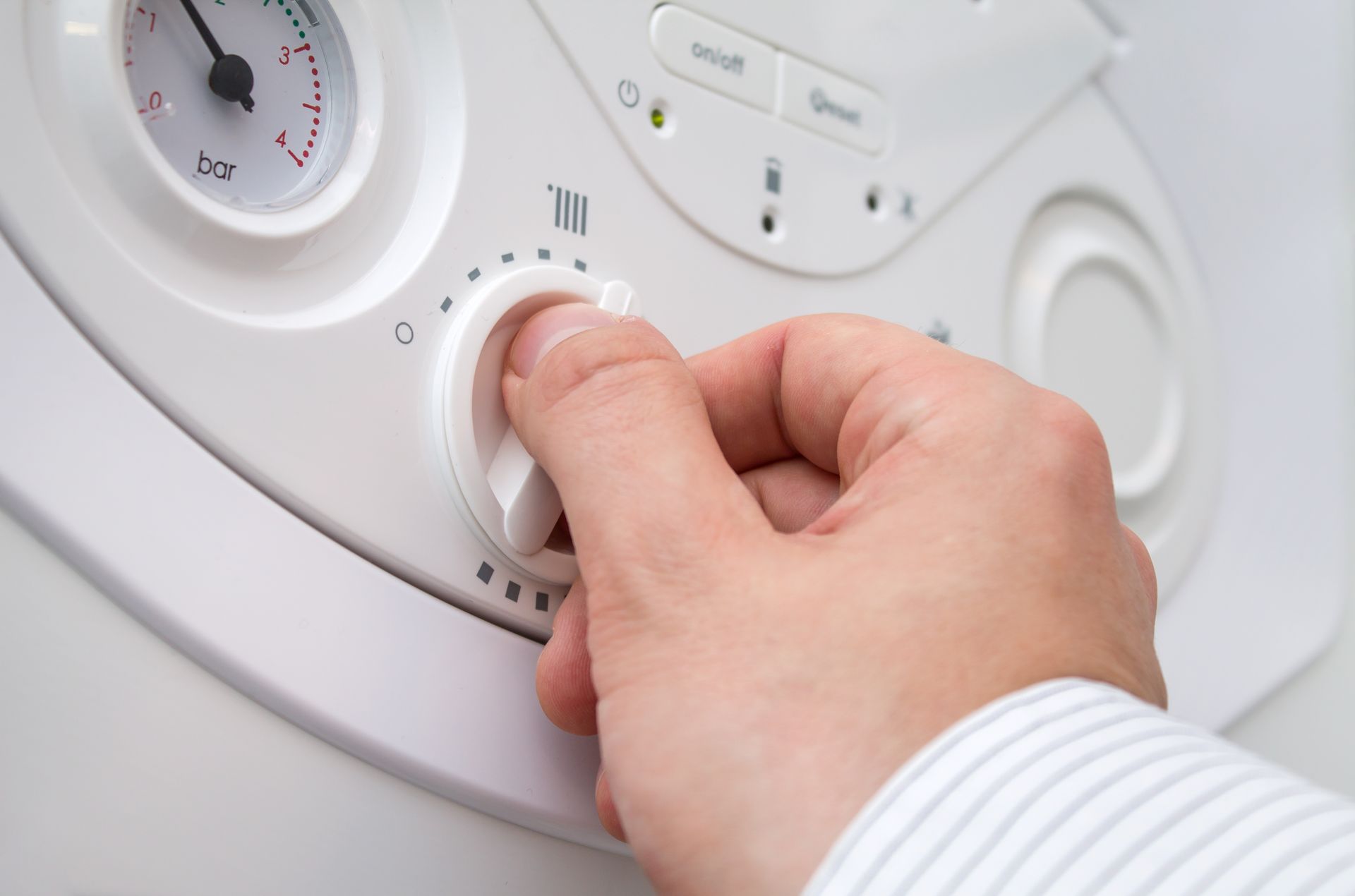 Un homme règle sa chaudière à gaz