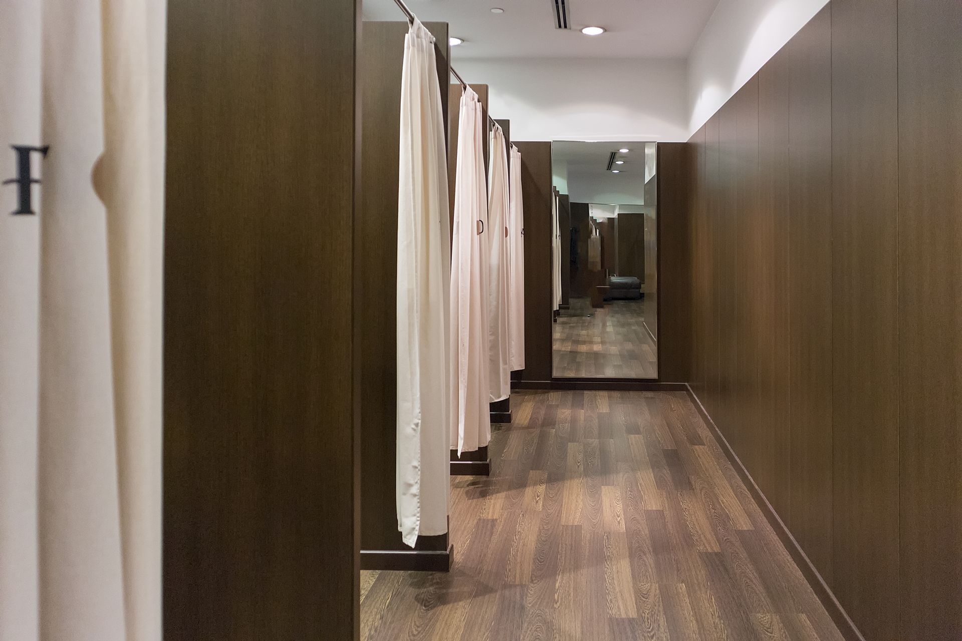 Plusieurs cabines d'essayage aux murs en bois sombre