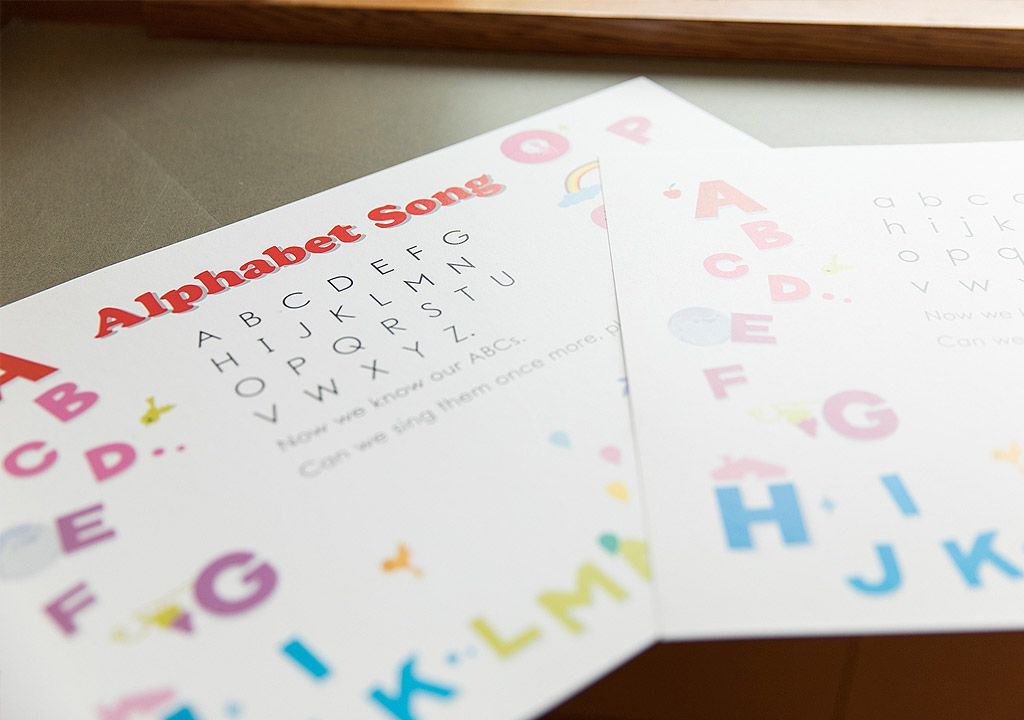 Two sheets of paper with the alphabet on them