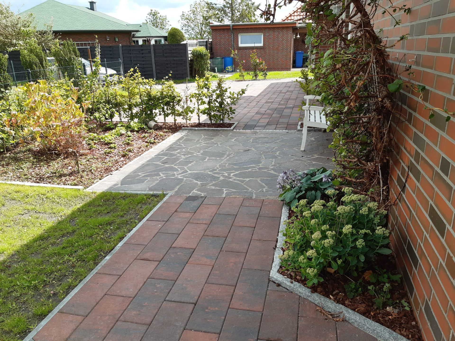 Ein gemauerter Gehweg, der zu einem gemauerten Haus führt