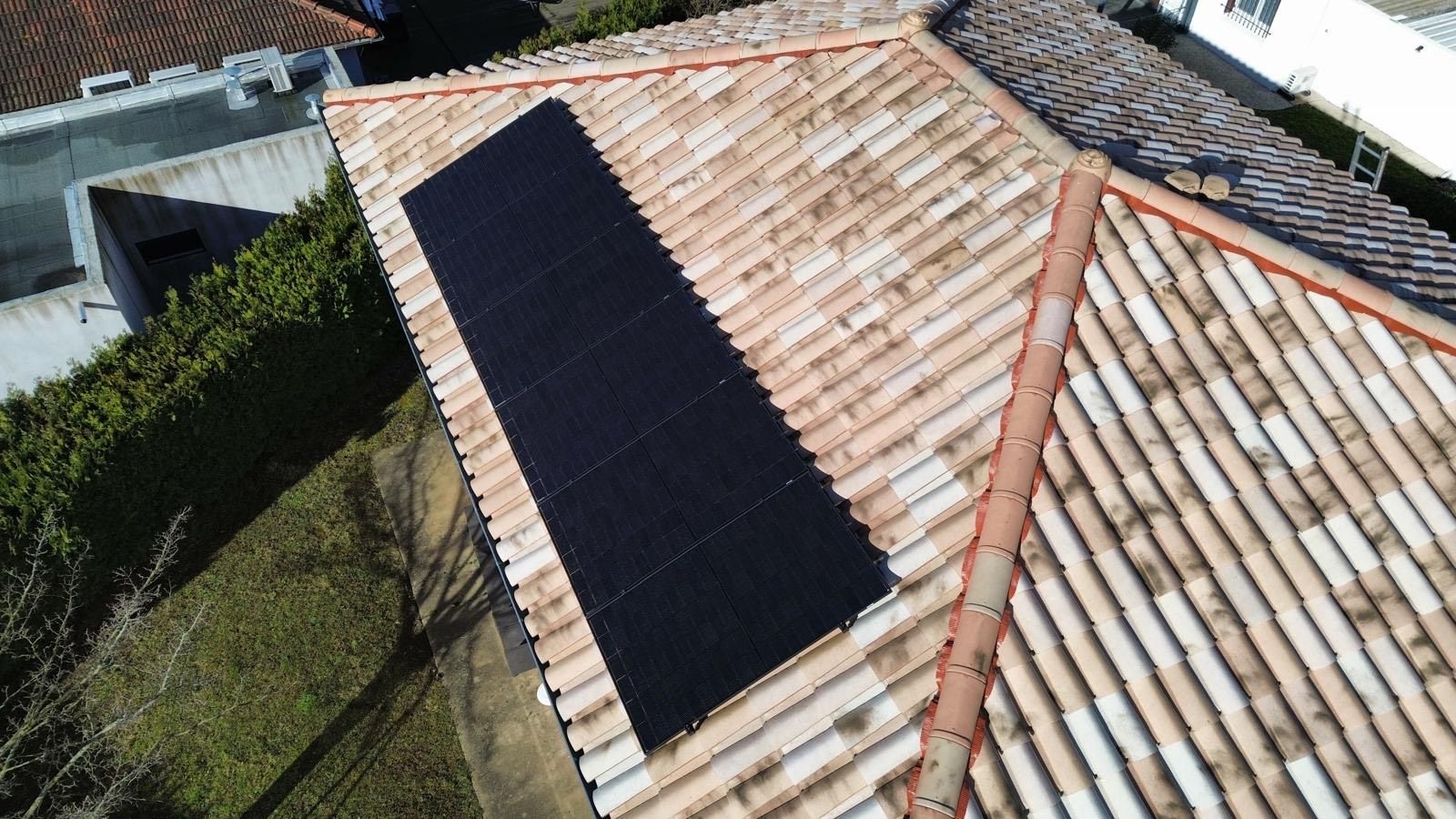Bande de panneaux photovoltaïques sur une toiture de maison.