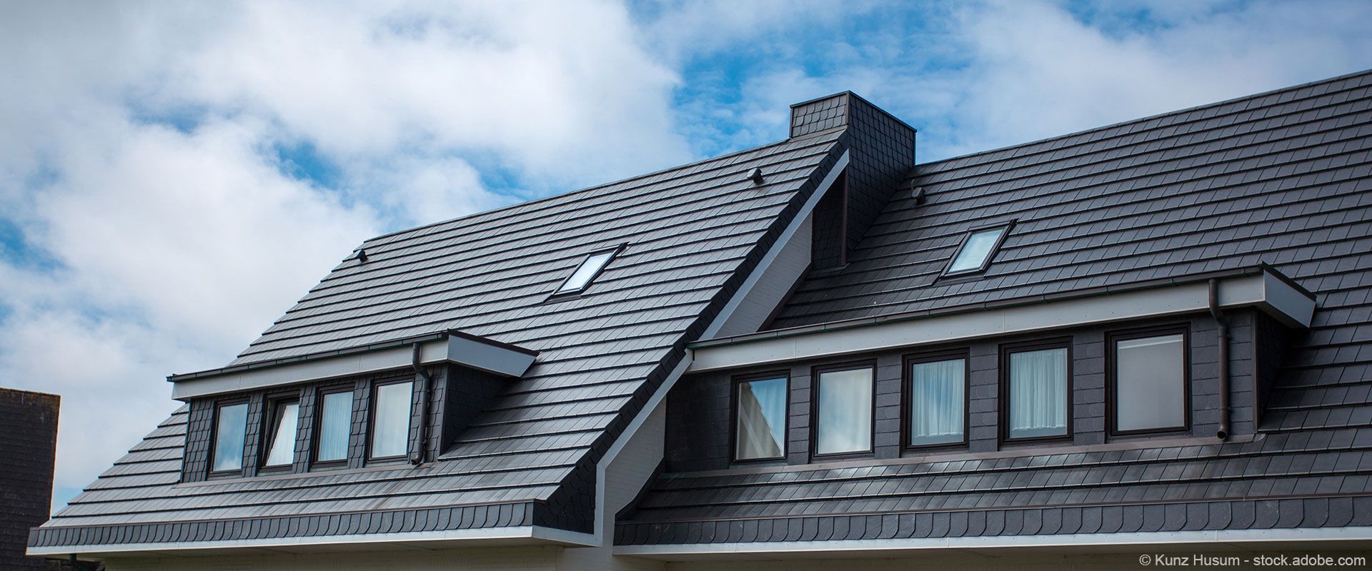 Eine Gruppe Männer arbeitet auf dem Dach eines Gebäudes.