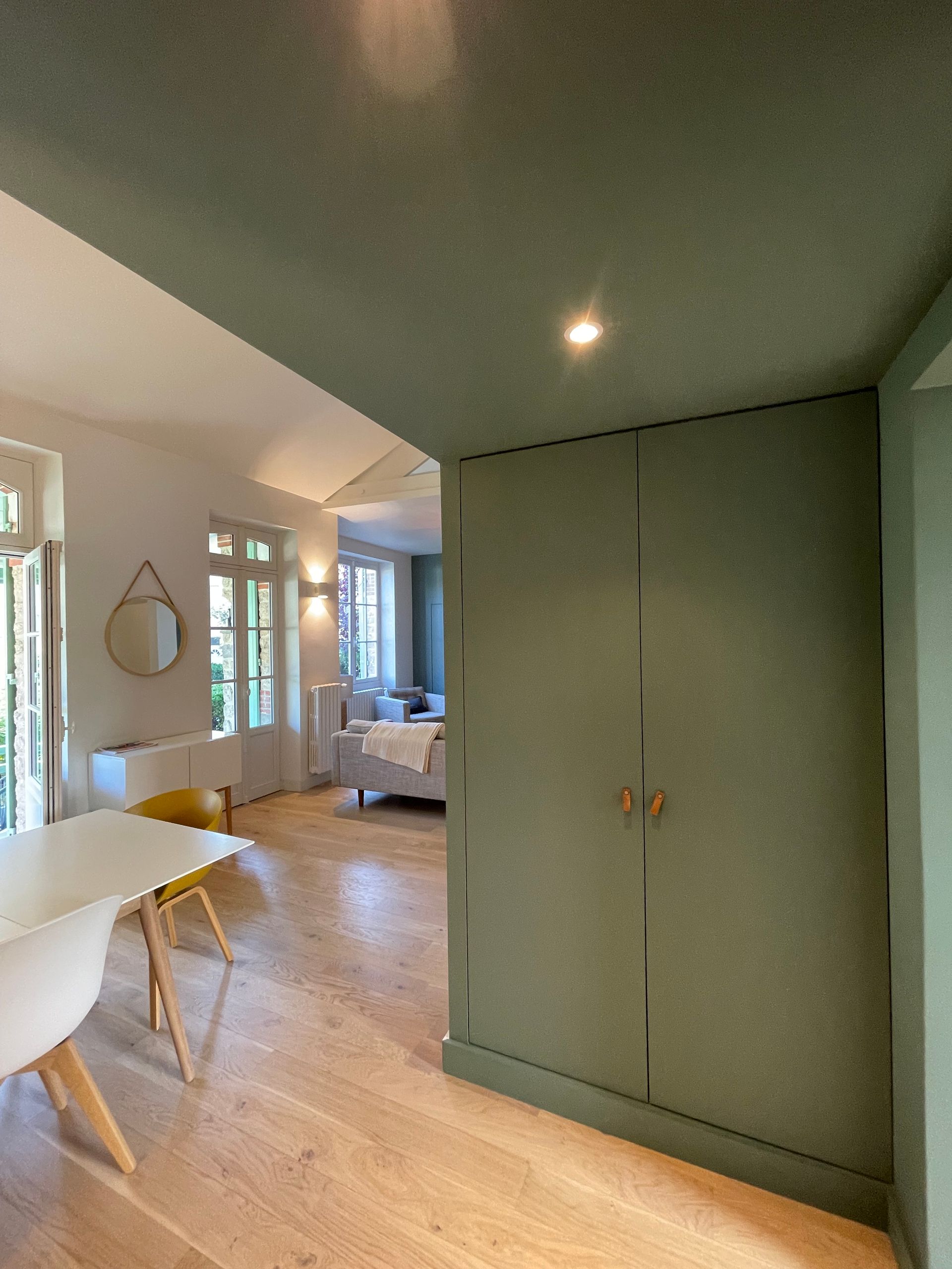 Vue sur un salon vert et blanc