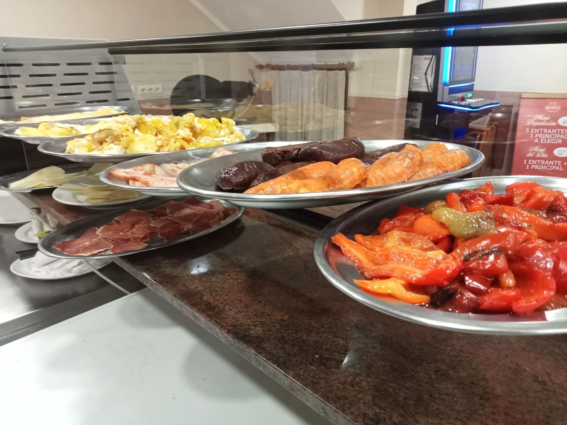 Los platos de comida están alineados en un mostrador en un restaurante.