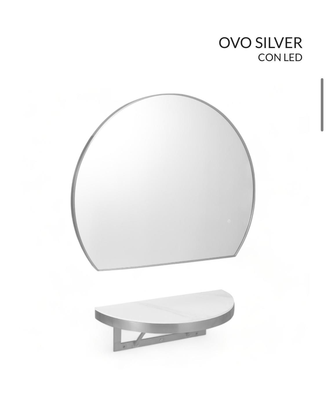 Un espejo redondo con un estante debajo.