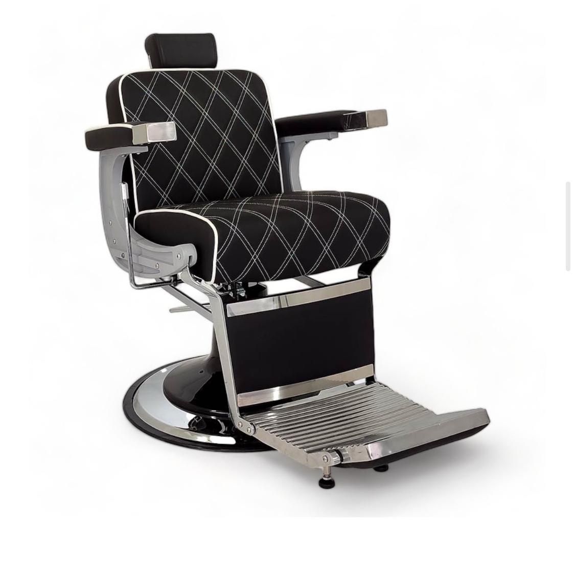 Una silla de barbero negra y plateada sobre un fondo blanco.