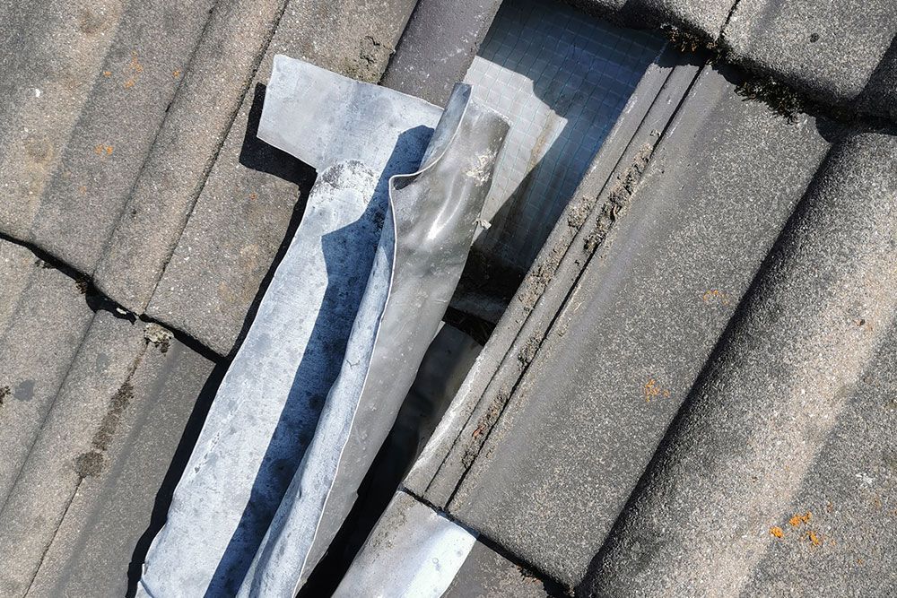 Ein Stück Metall liegt auf einer Betonoberfläche. Christian Nippel Dachdecker-Meisterbetrieb GmbH