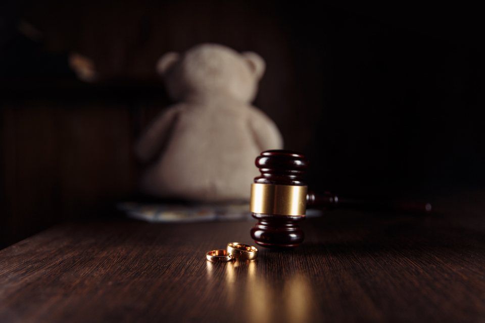 Unscharf abgebildeter Teddybär im Hintergrund, vorne Hammer, Rechtsanwälte Wernitz & Kollegen