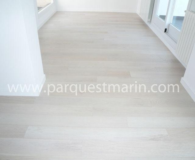 Una habitación con suelo blanco y la página web www.parquetmarin.com