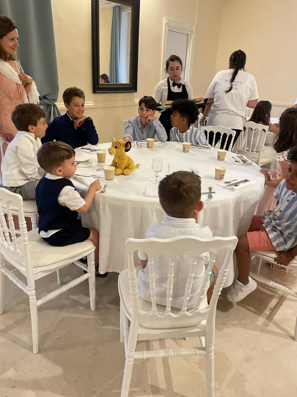 Des enfants sont assis autour d'une table d'un mariage.