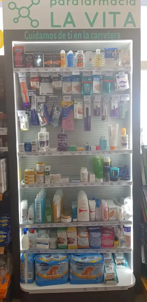Vitrina de farmacia con una variedad de medicamentos, artículos de aseo personal y productos para la salud en los estantes.