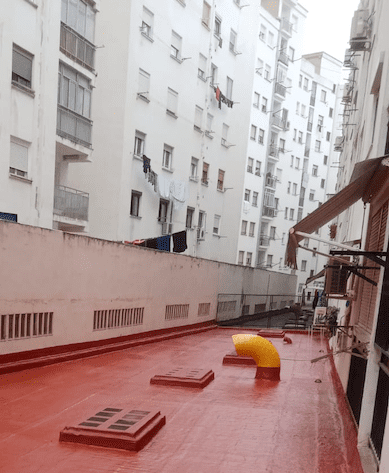 Una hilera de edificios con una tubería amarilla en el medio