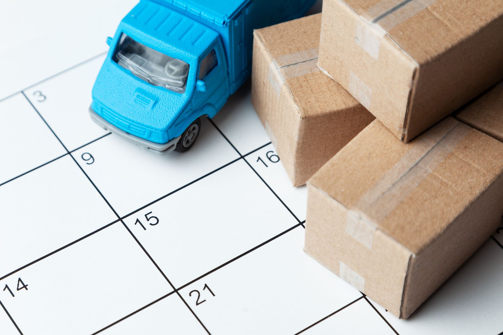 Camion et cartons miniatures posés sur un calendrier papier