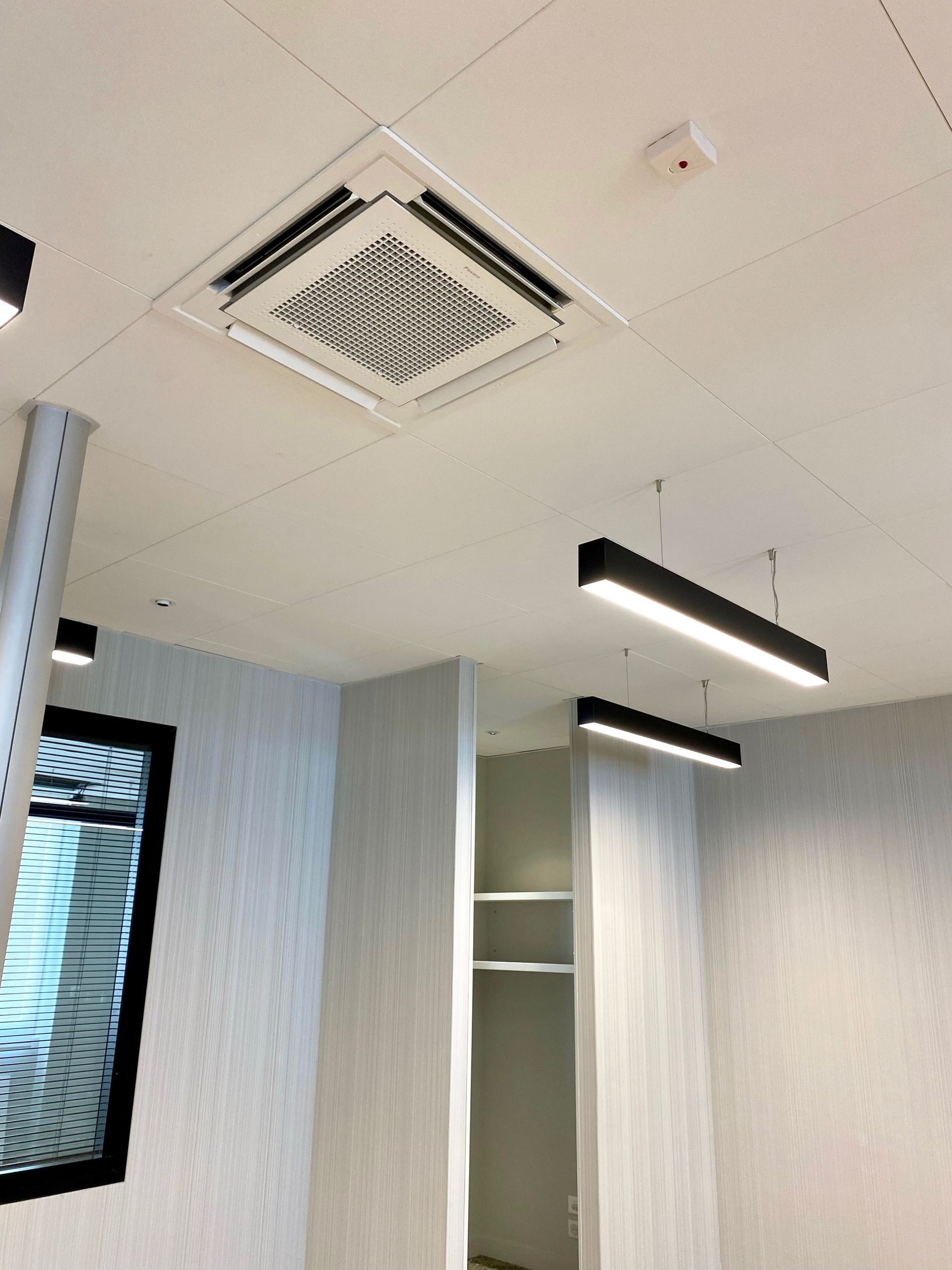 Climatiseur au plafond d'une pièce avec verrière