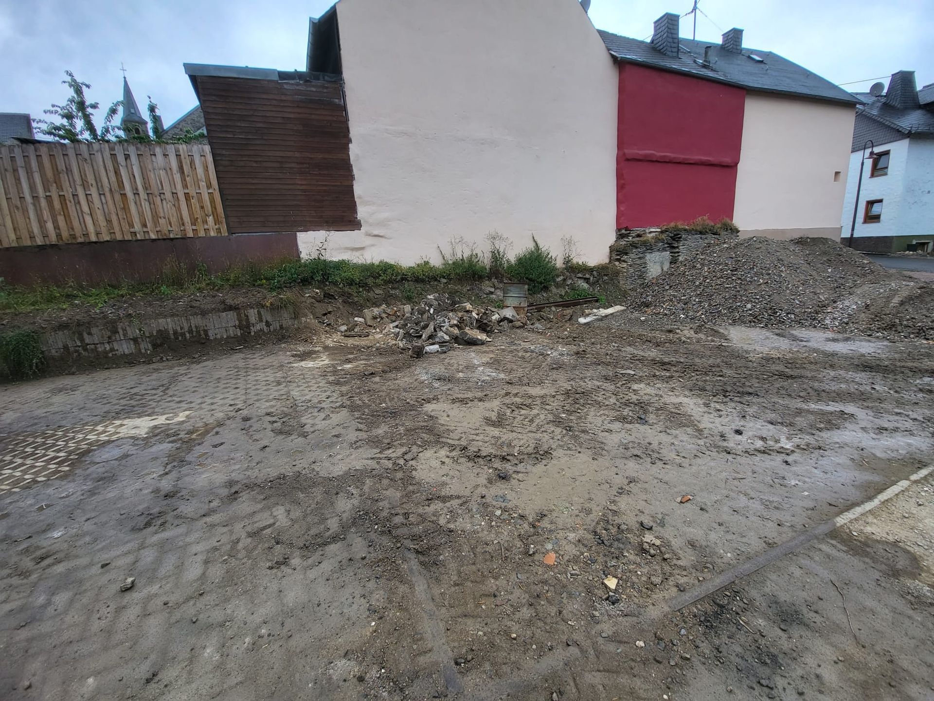 Ein Gebäude mit einer roten Tür und einer weißen Wand wird abgerissen.