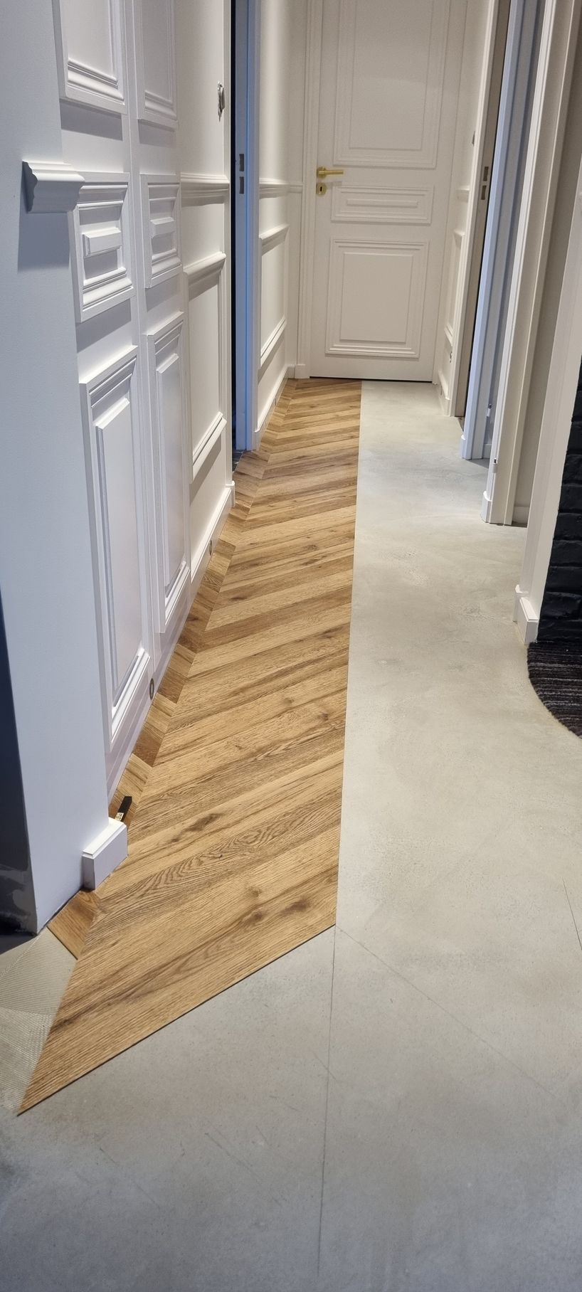 Pose en cours de lames LVT à coller dans un couloir