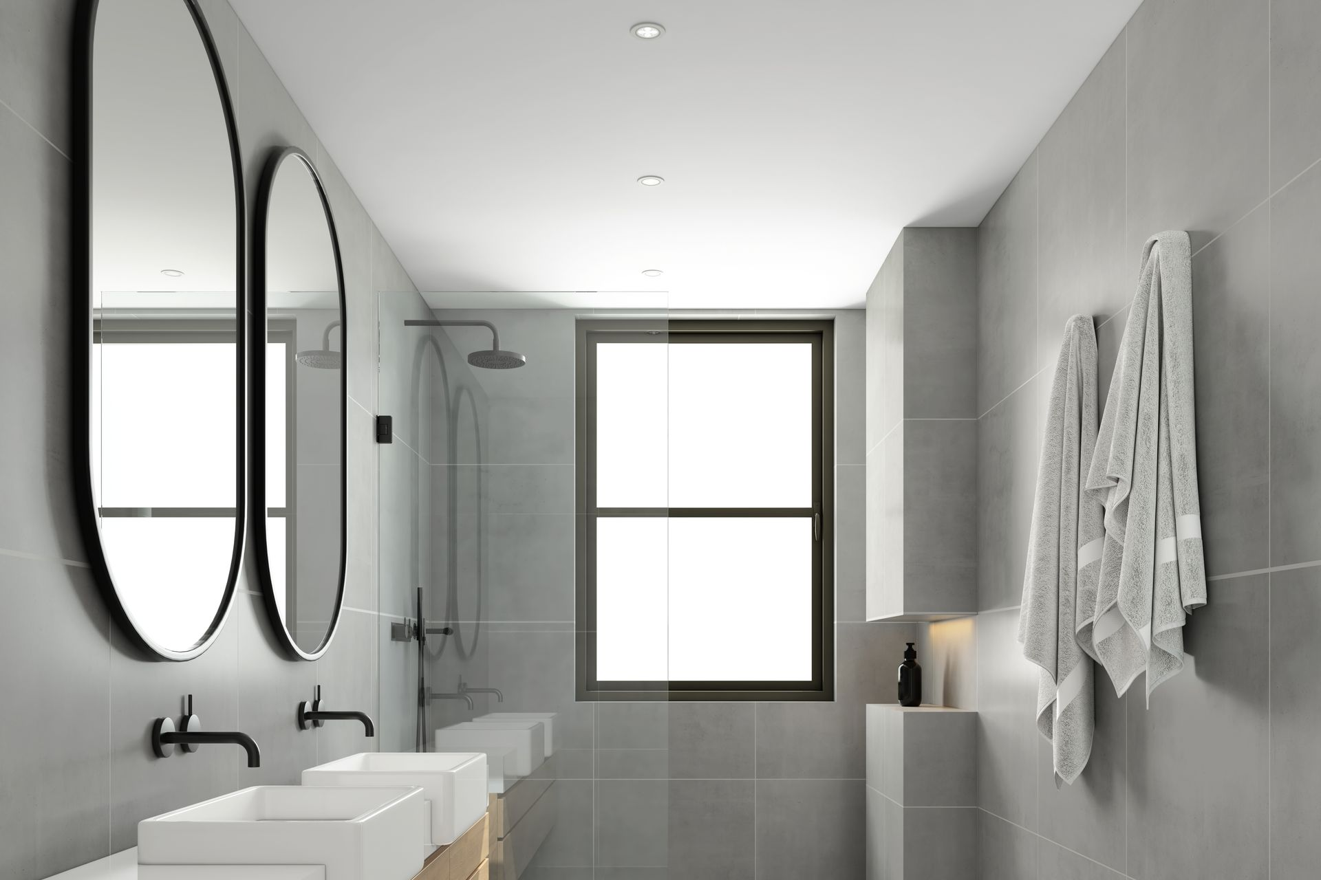 Des serviettes accrochées et des miroirs au mur avec des vasques