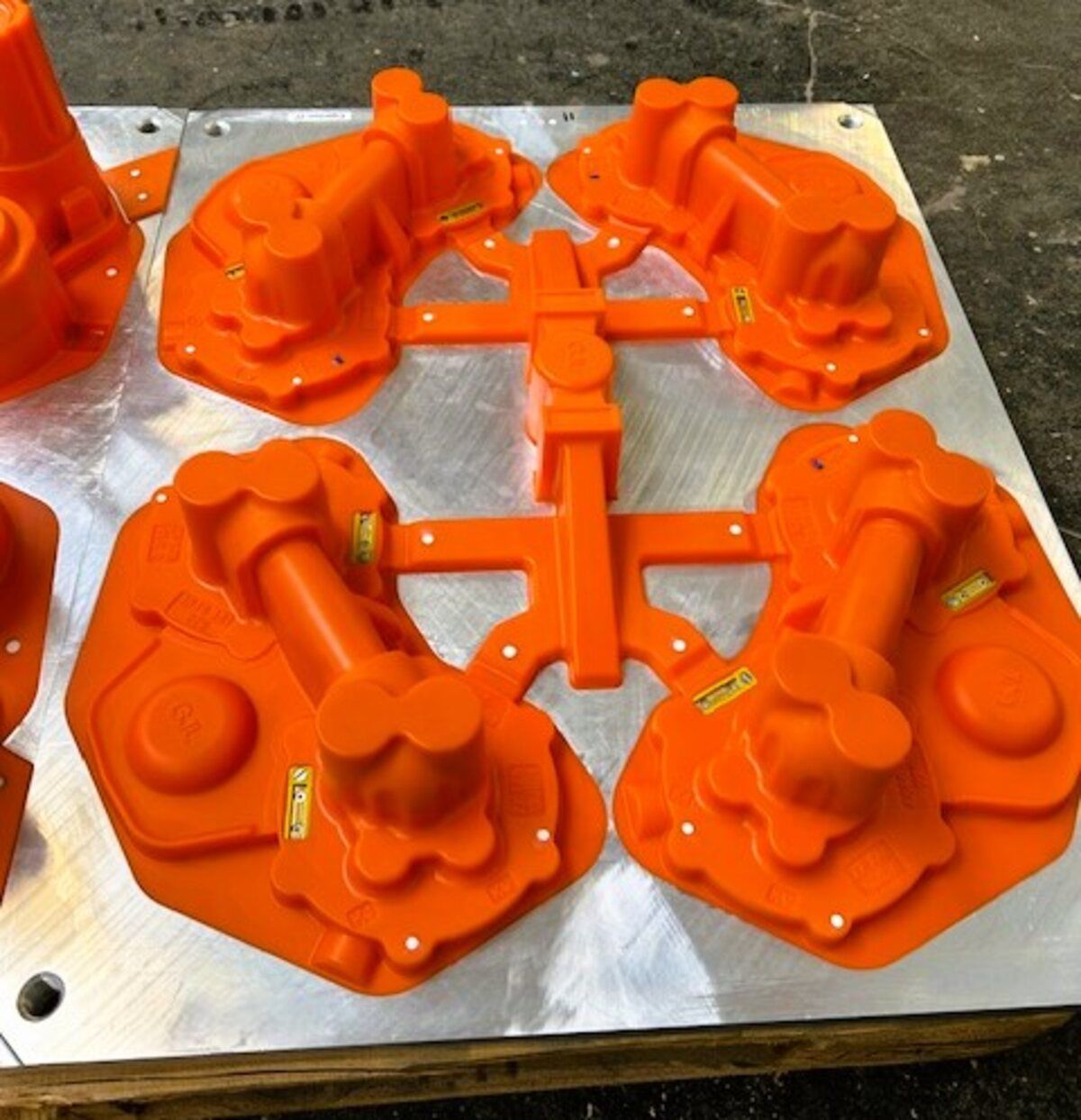 Ein Haufen orangefarbener Prototypen auf einer Metallplatte