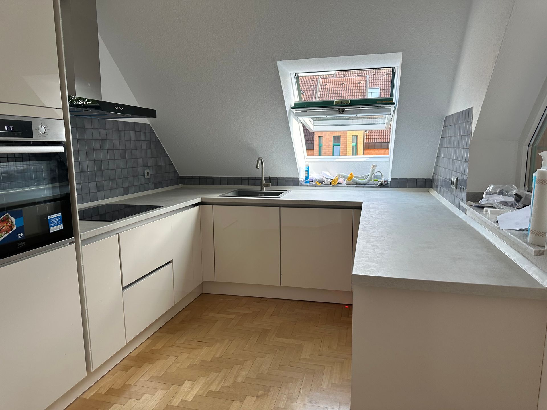 Eine Küche mit weißen Schränken und einem Herd