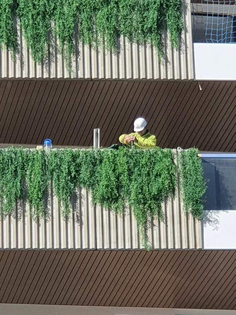 Un hombre está sentado en el balcón de un edificio.