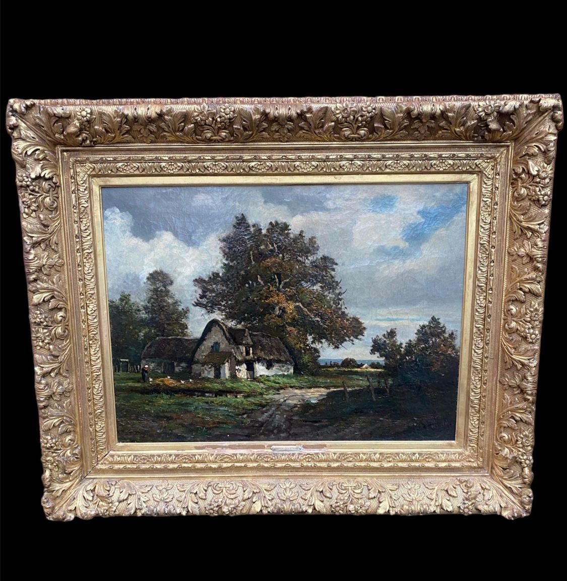 Strasbourg antiquaire - toile représentant une maison de campagne avec un cadre aux moulures fleuries