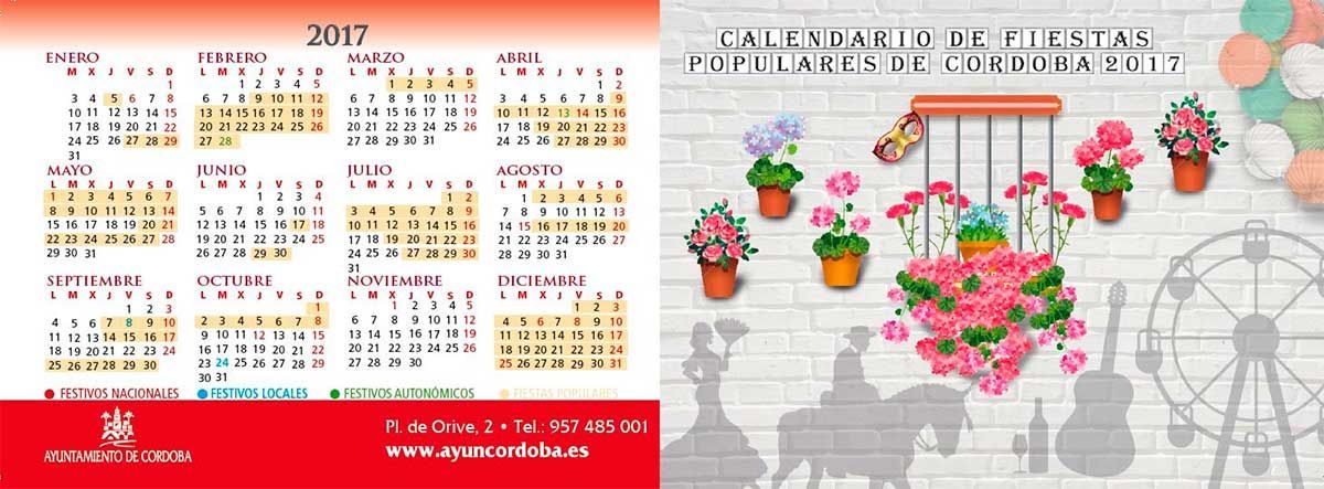 Un calendario y una imagen de flores en una pared de ladrillos.