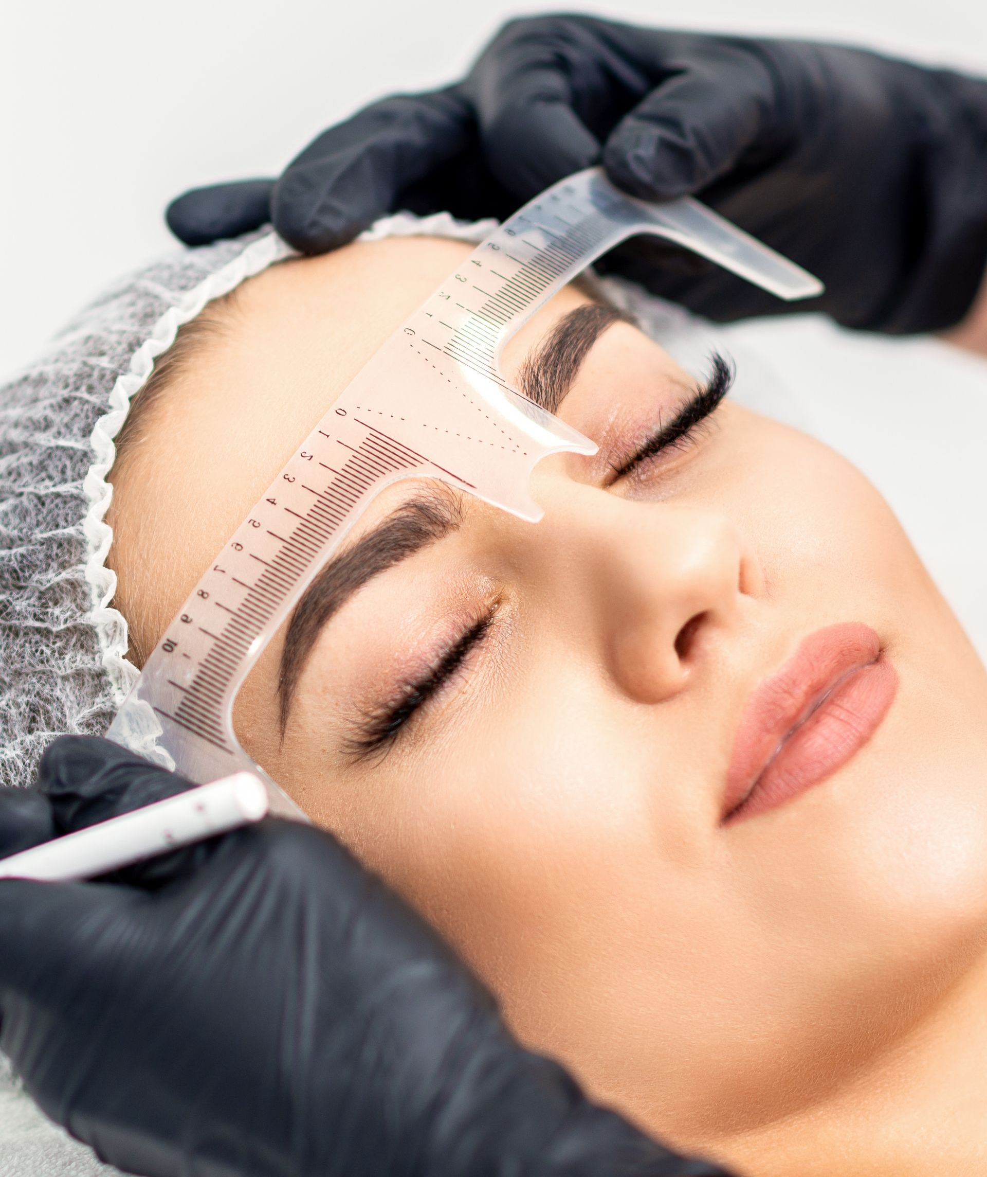 Personne se faisant épiler les sourcils au pochoir et au crayon.