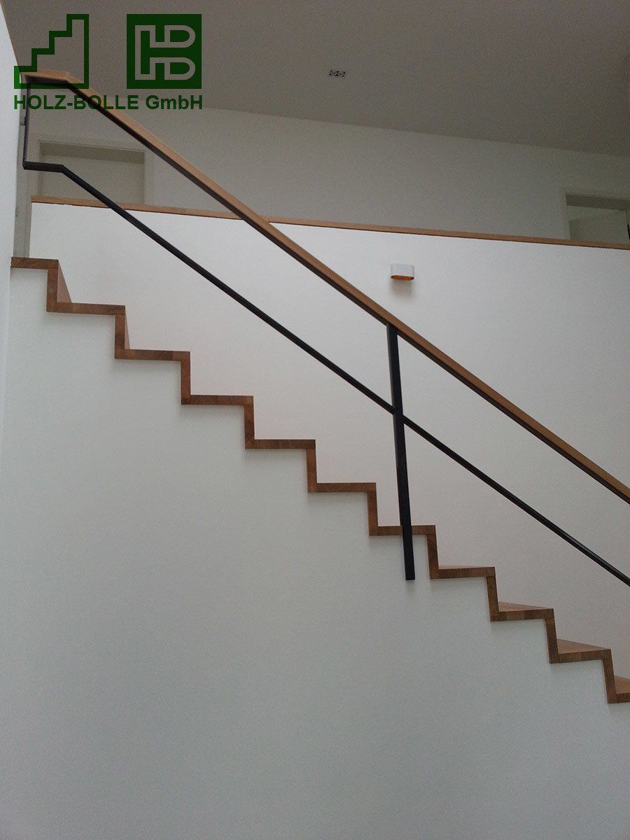 Eine Holztreppe mit einem Metallgeländer und einem Schild mit der Aufschrift „hb“