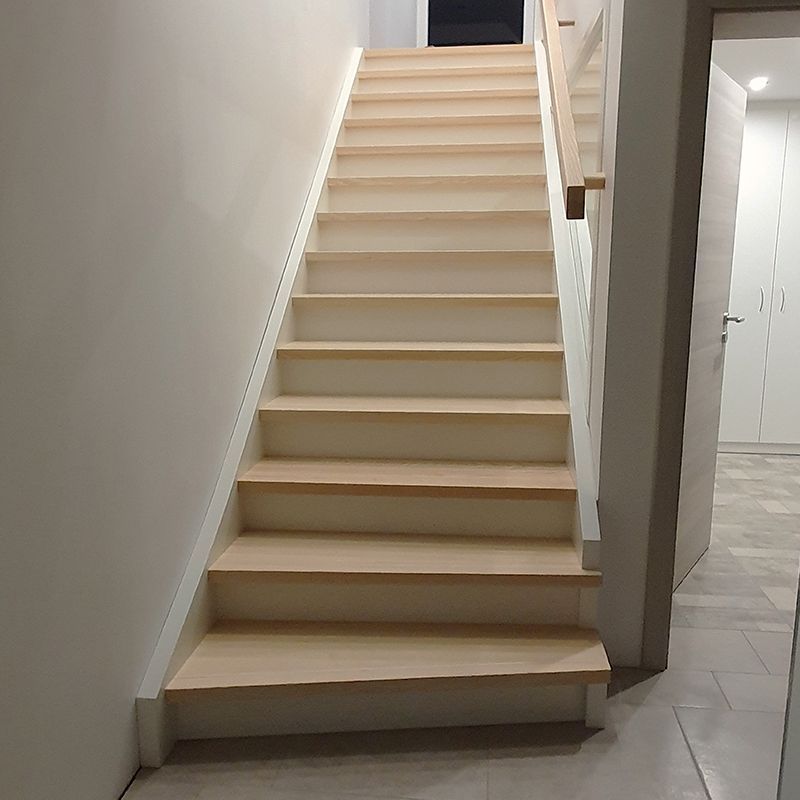 Eine Holztreppe führt in den zweiten Stock eines Hauses.