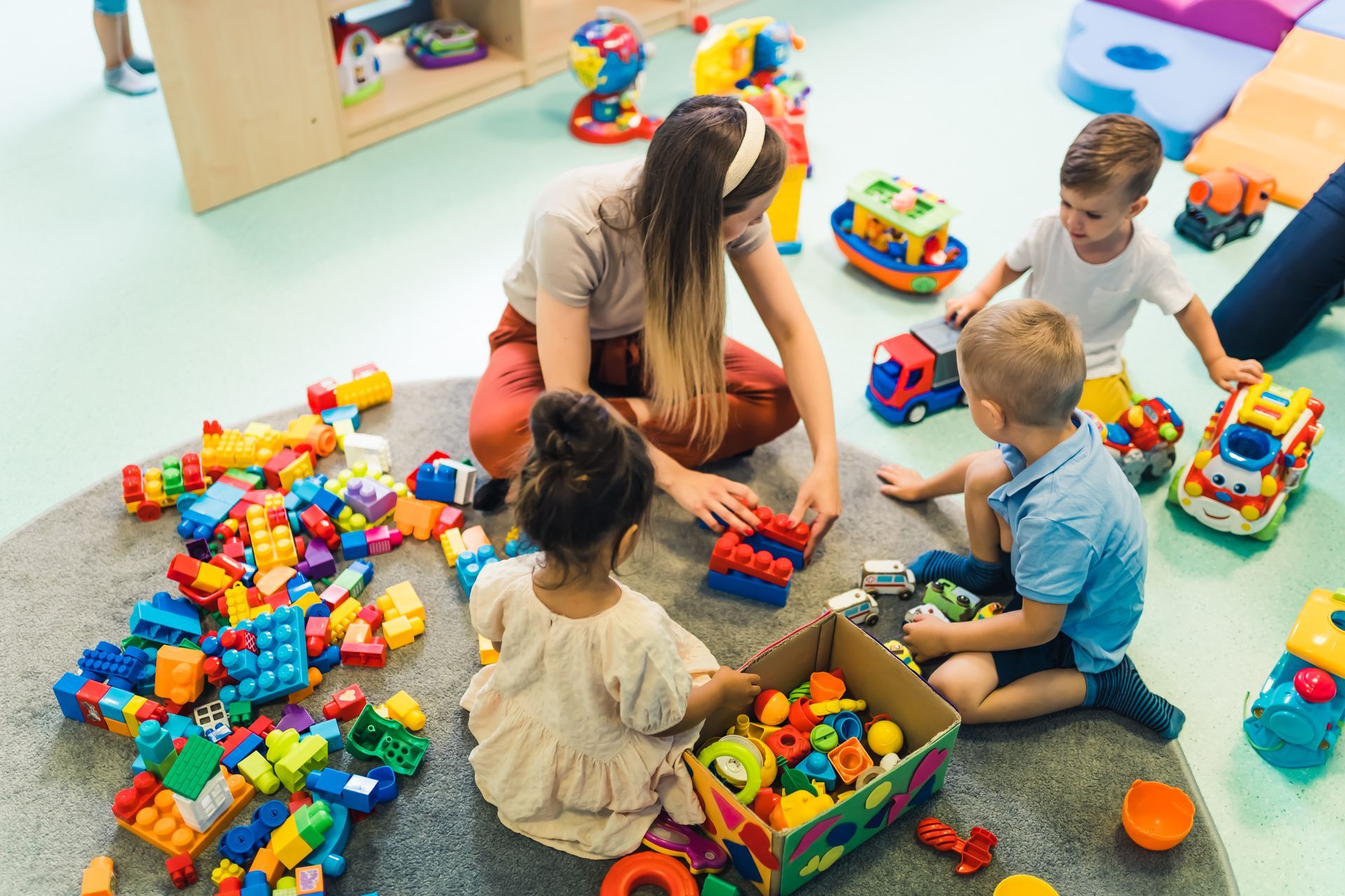 Enfants participant à une activité d’éveil avec des briques de construction colorées dans une crèche