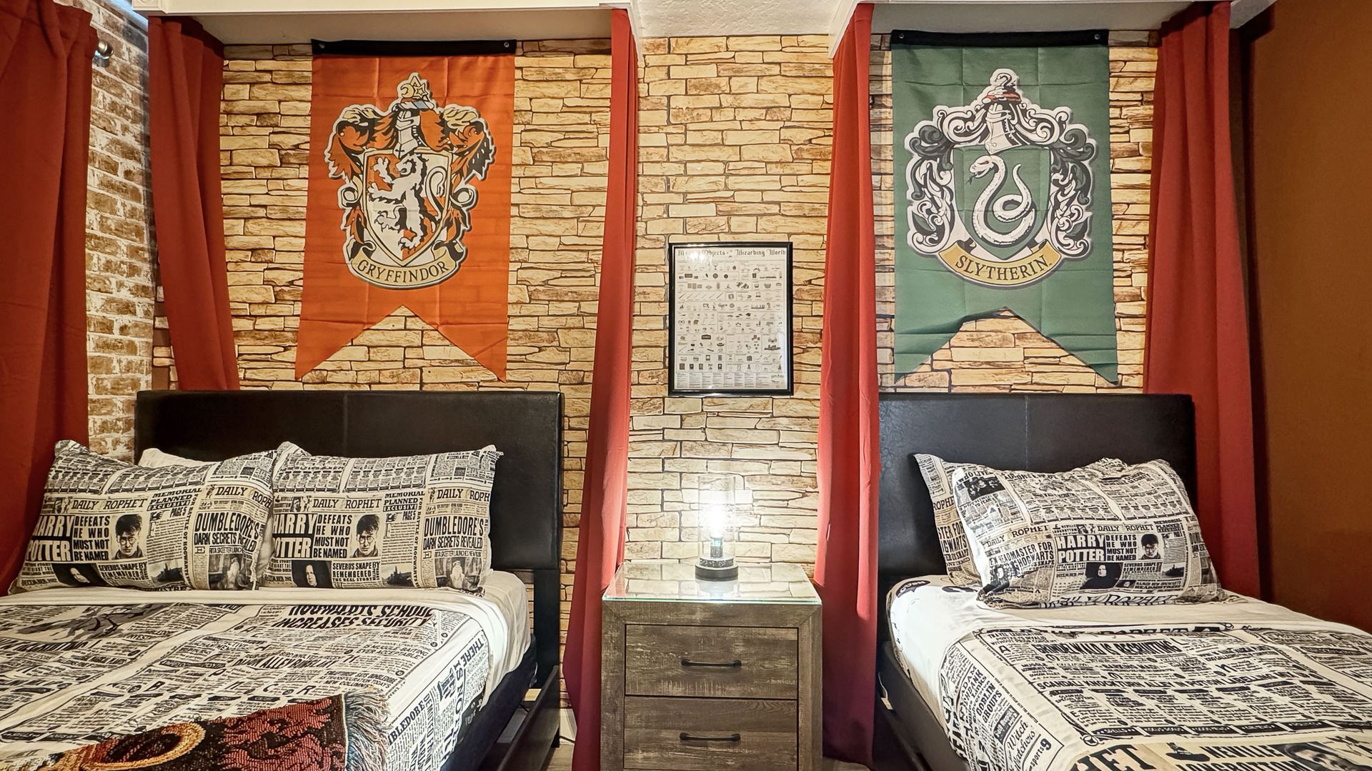 A bedroom with two beds , a nightstand and a clock on the wall.