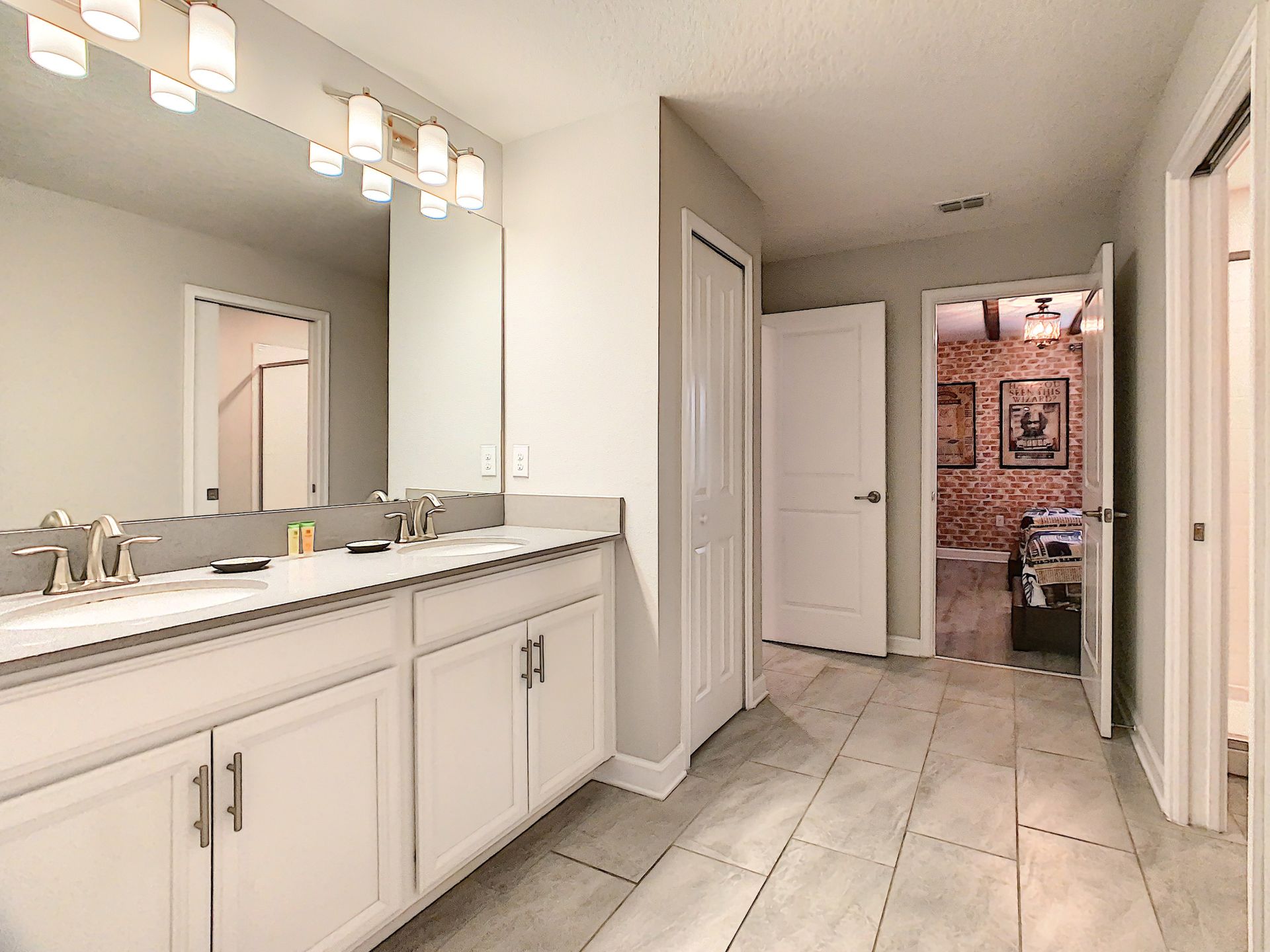 A bathroom with two sinks and a large mirror.