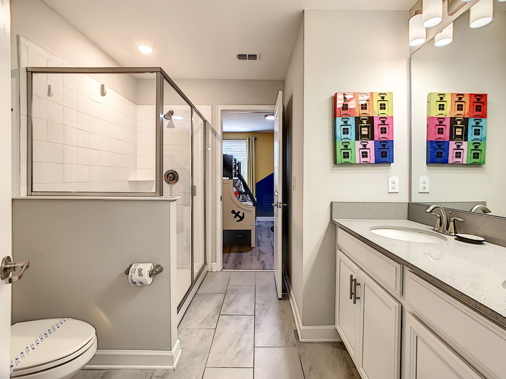 A bathroom with a toilet , sink , and shower.