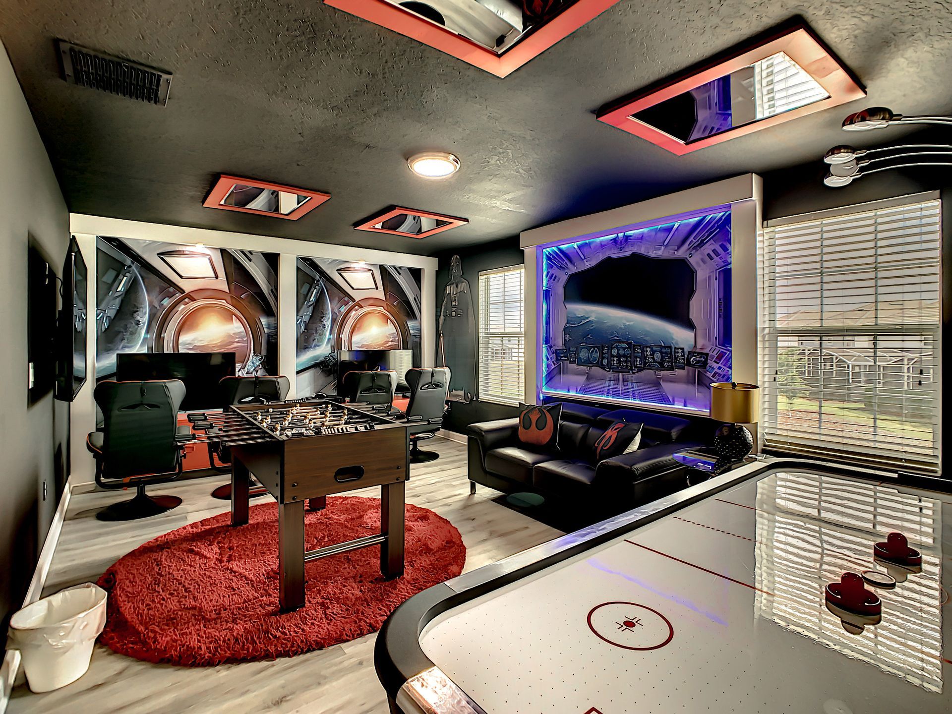 A game room with a table and a couch