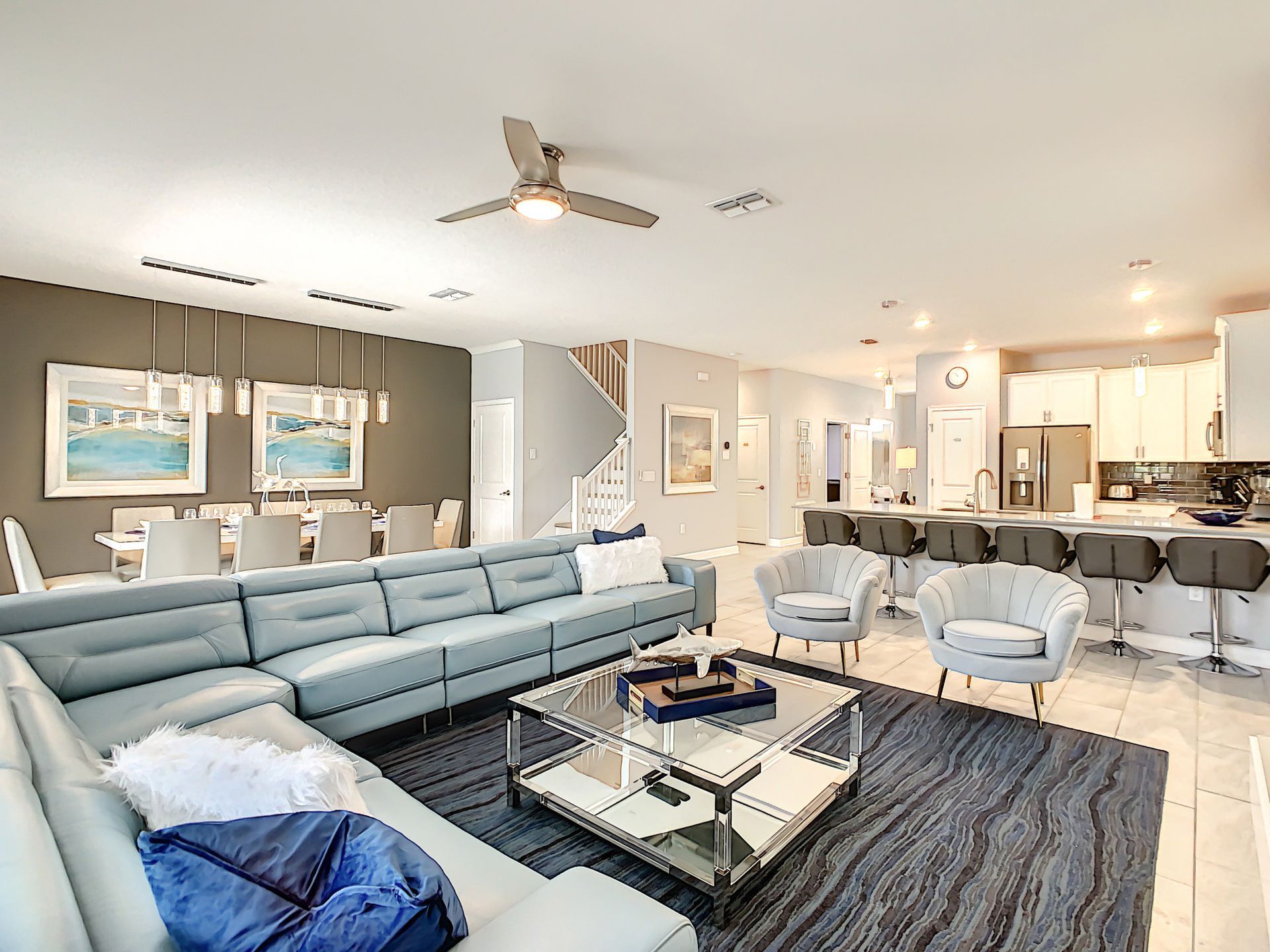 A living room filled with furniture and a ceiling fan.