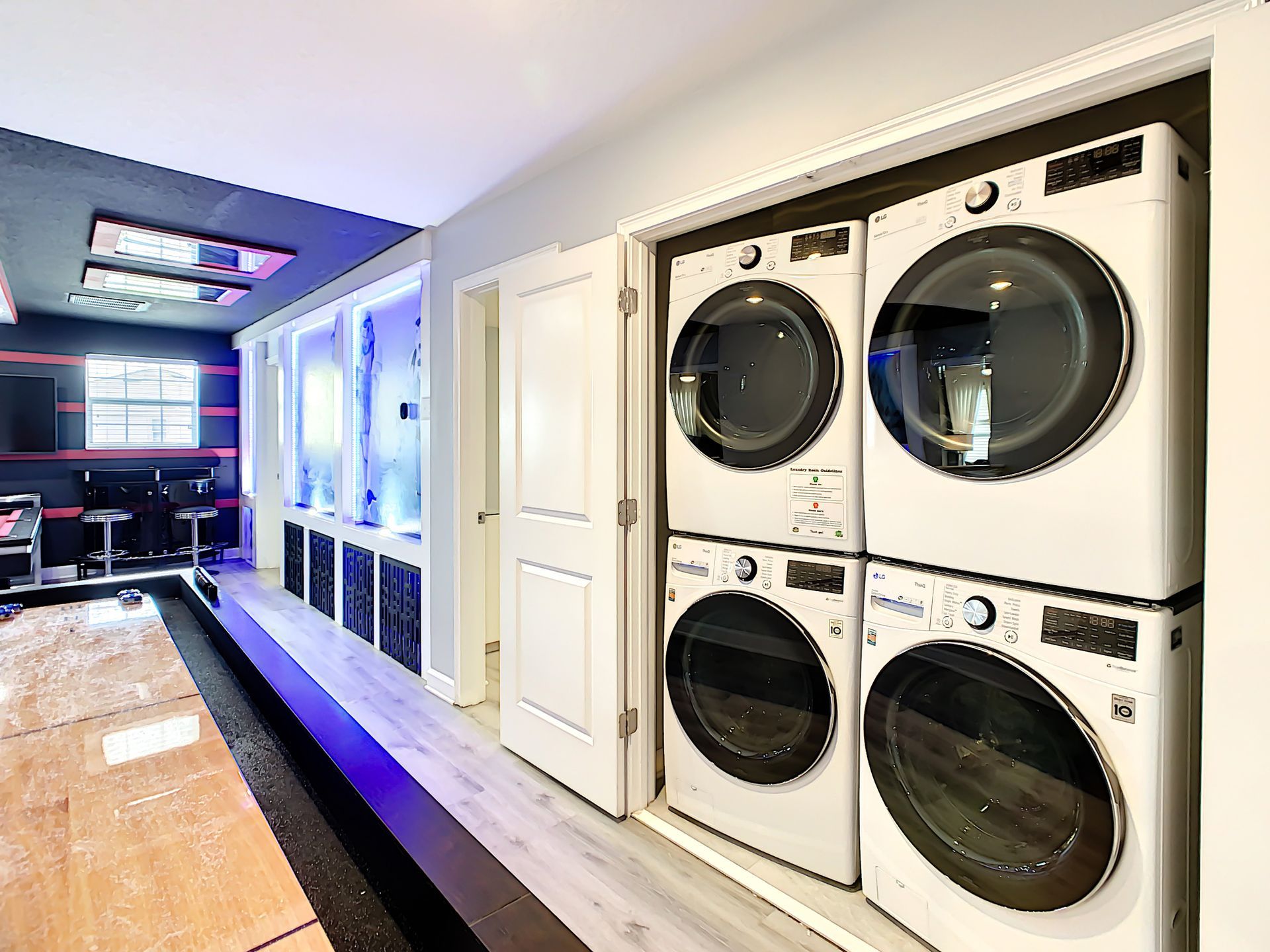 A laundry room with a washer and dryer stacked on top of each other.
