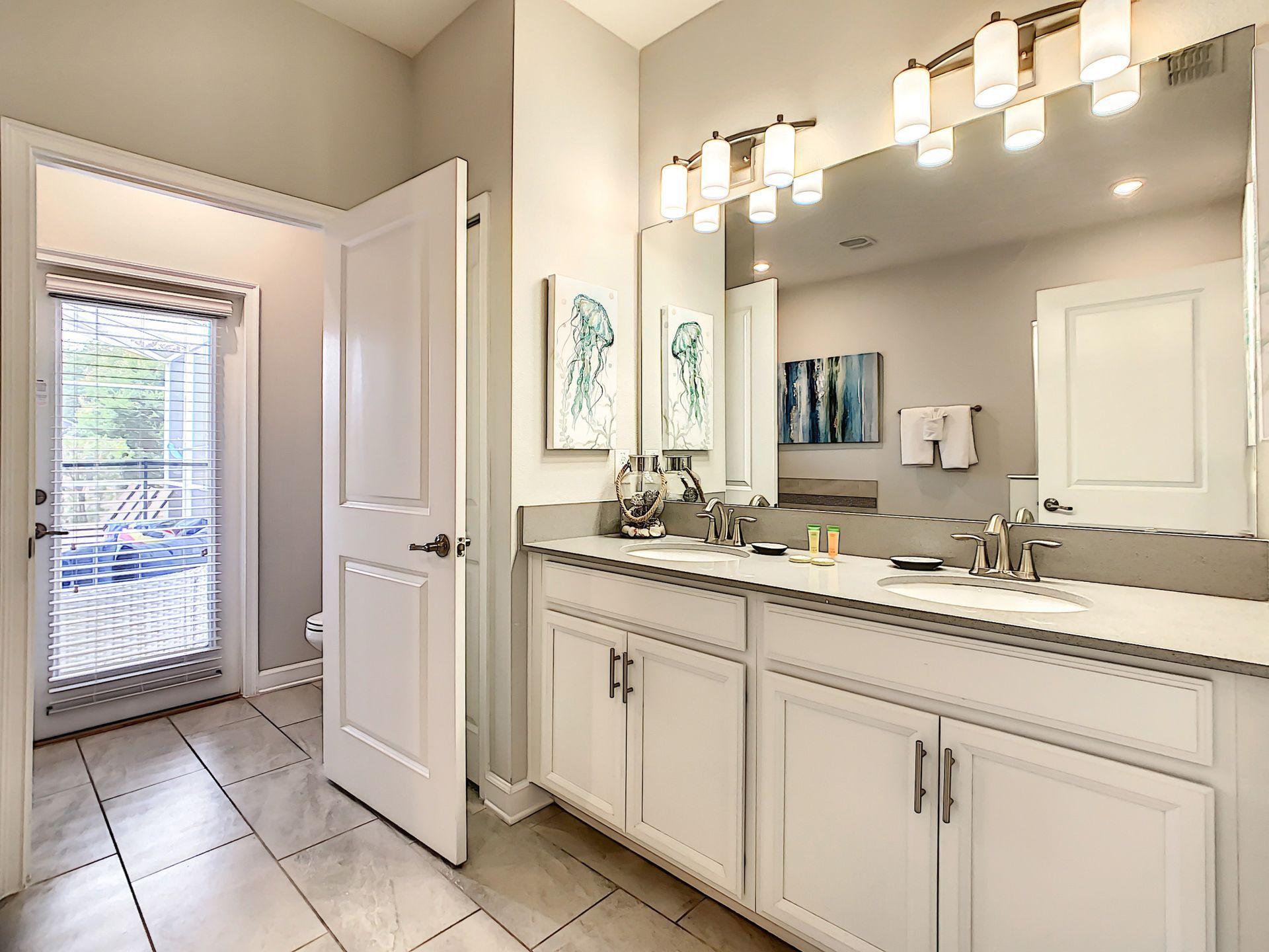 A bathroom with two sinks and a large mirror.