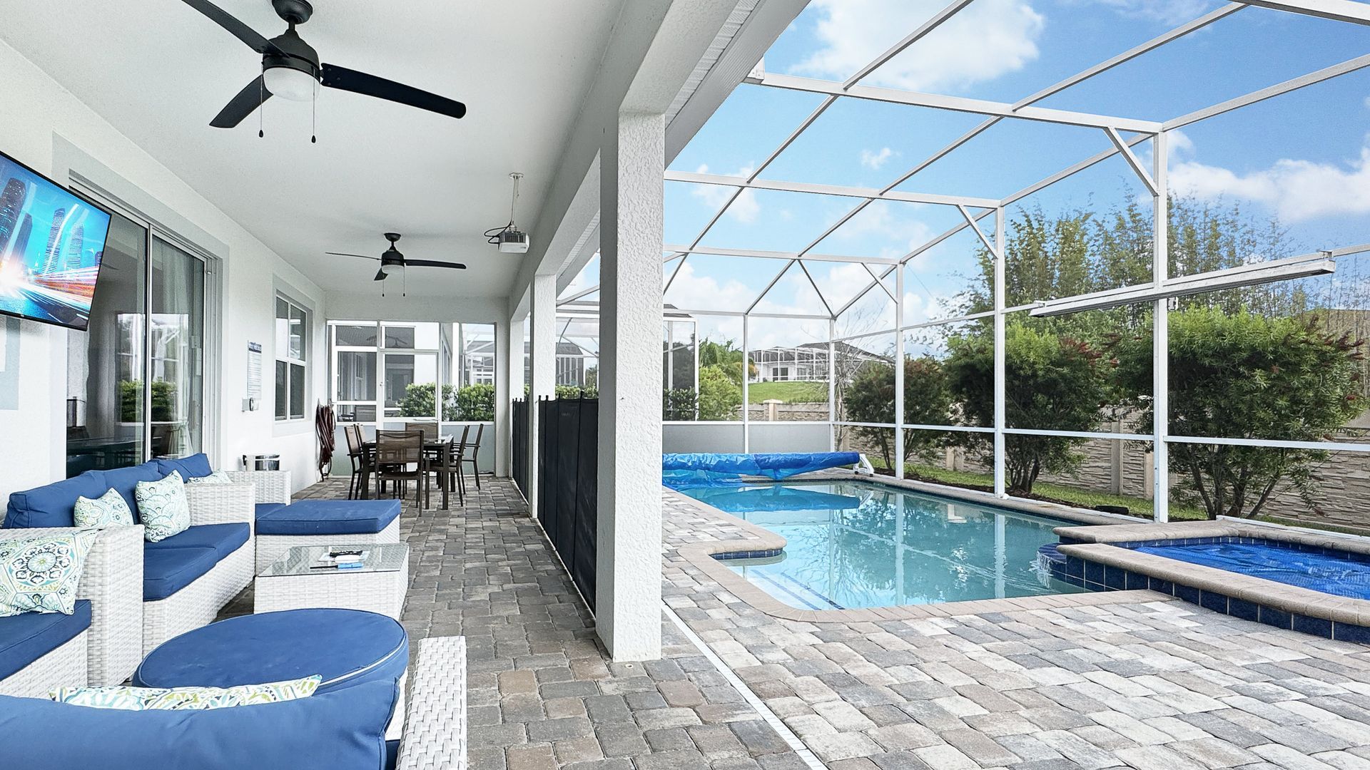 There is a large swimming pool in the backyard of a house.